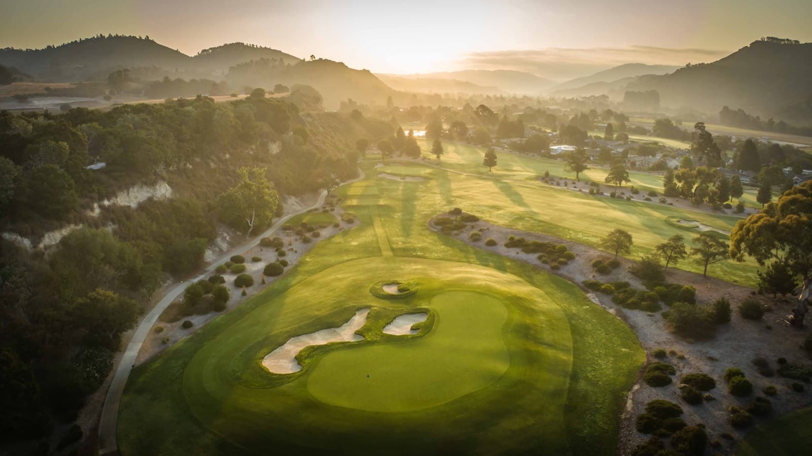 Aerial view of a bunkered green at Quail Lodge Golf Club.