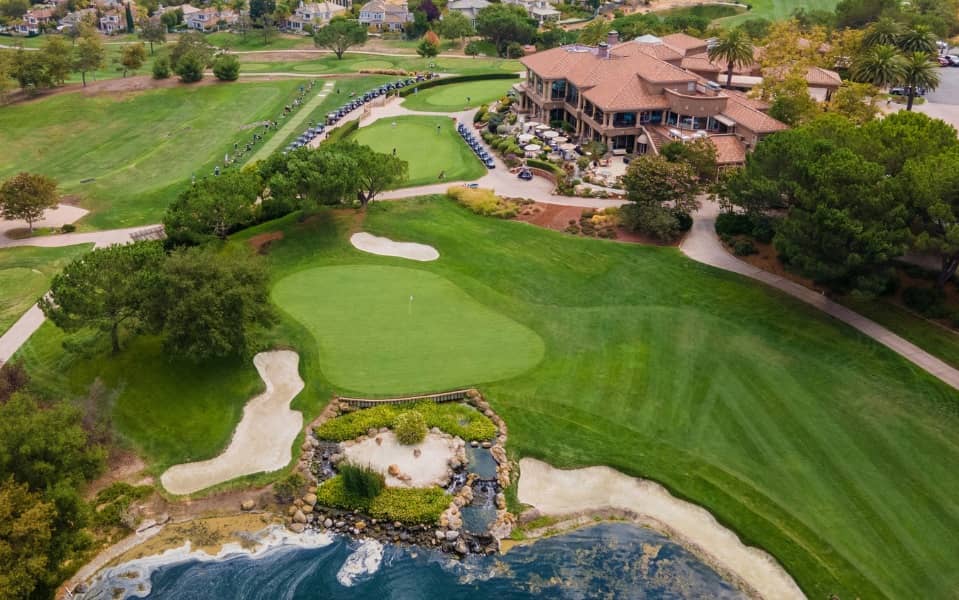 Aerial view of a green and the clubhouse at Silver Creek Valley Country Club in San Jose.