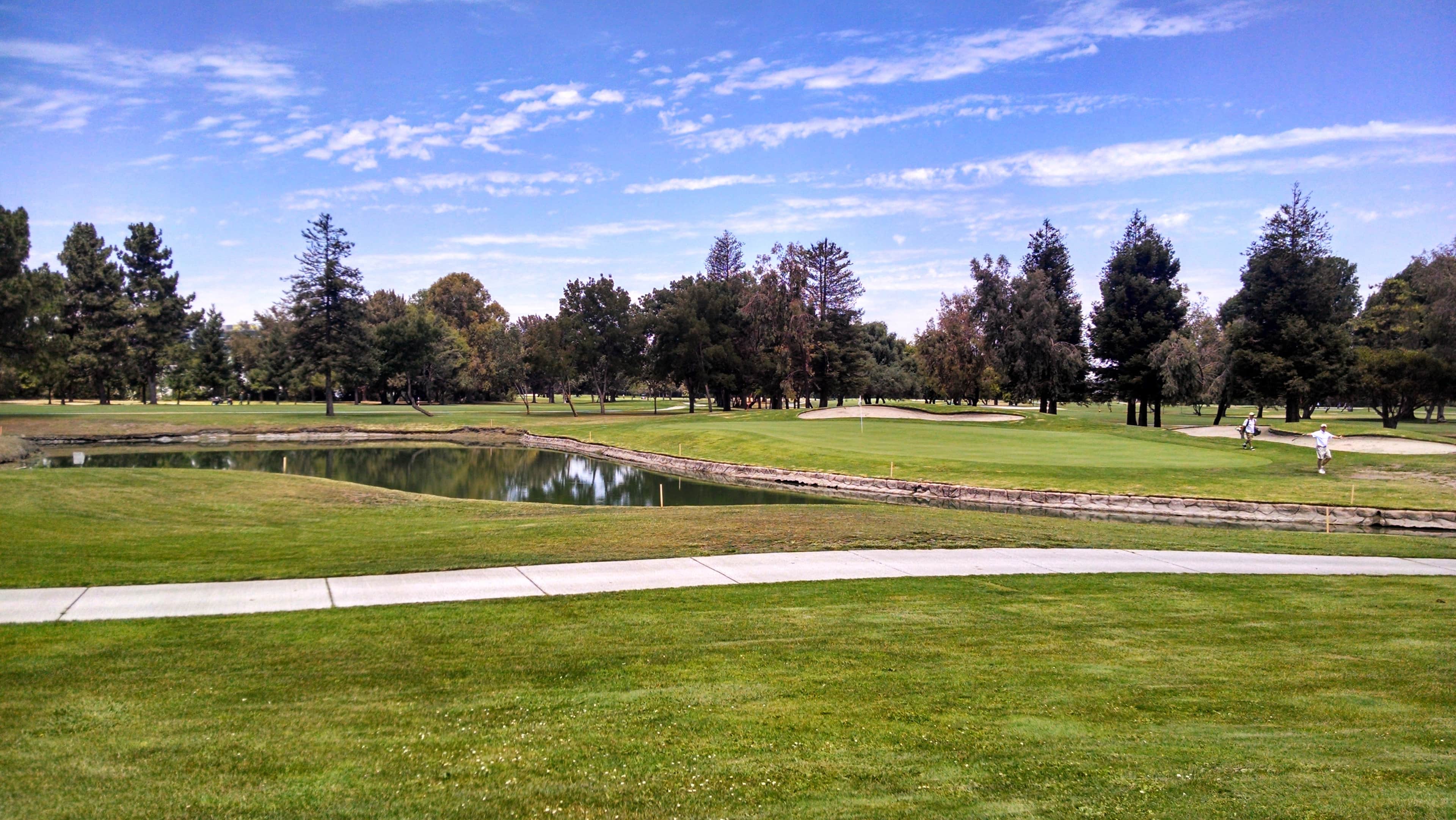 View across the greens toward a lake and cart path at Sunken Gardens Golf Course, Sunnyvale, CA. Photo credit: Courtesy of Sunnyvale Municipal Golf Courses (sunnyvalegolfcourses.com).