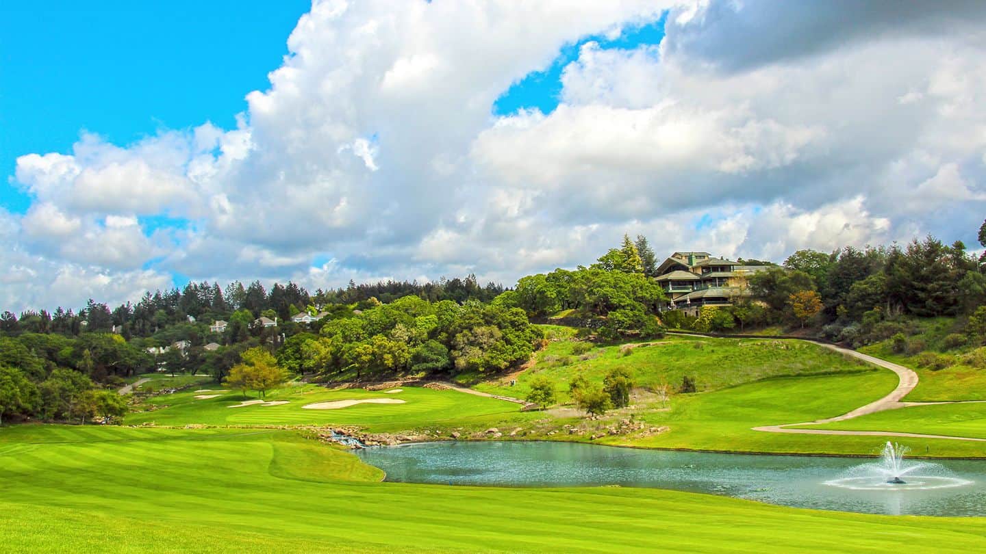 A sunny view over the water of the par-4 18th hole at The Fountaingrove Club, Santa Rosa, CA. Photo credit: The Fountaingrove Club (via GolfPass).