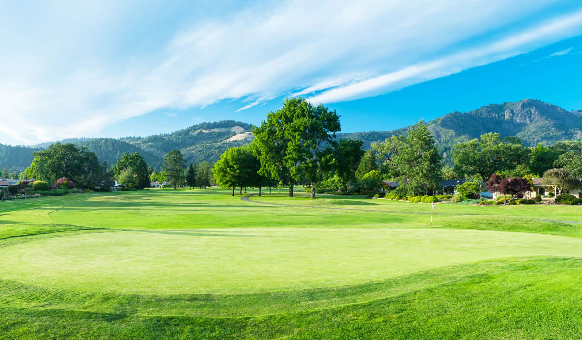 A putting green and fairway on the West / Valley of the Moon course at Oakmont Golf Club in Santa Rosa, CA, framed by the Sonoma mountains. Photo courtesy of Valley of the Moon Club (official website, playvom.com).