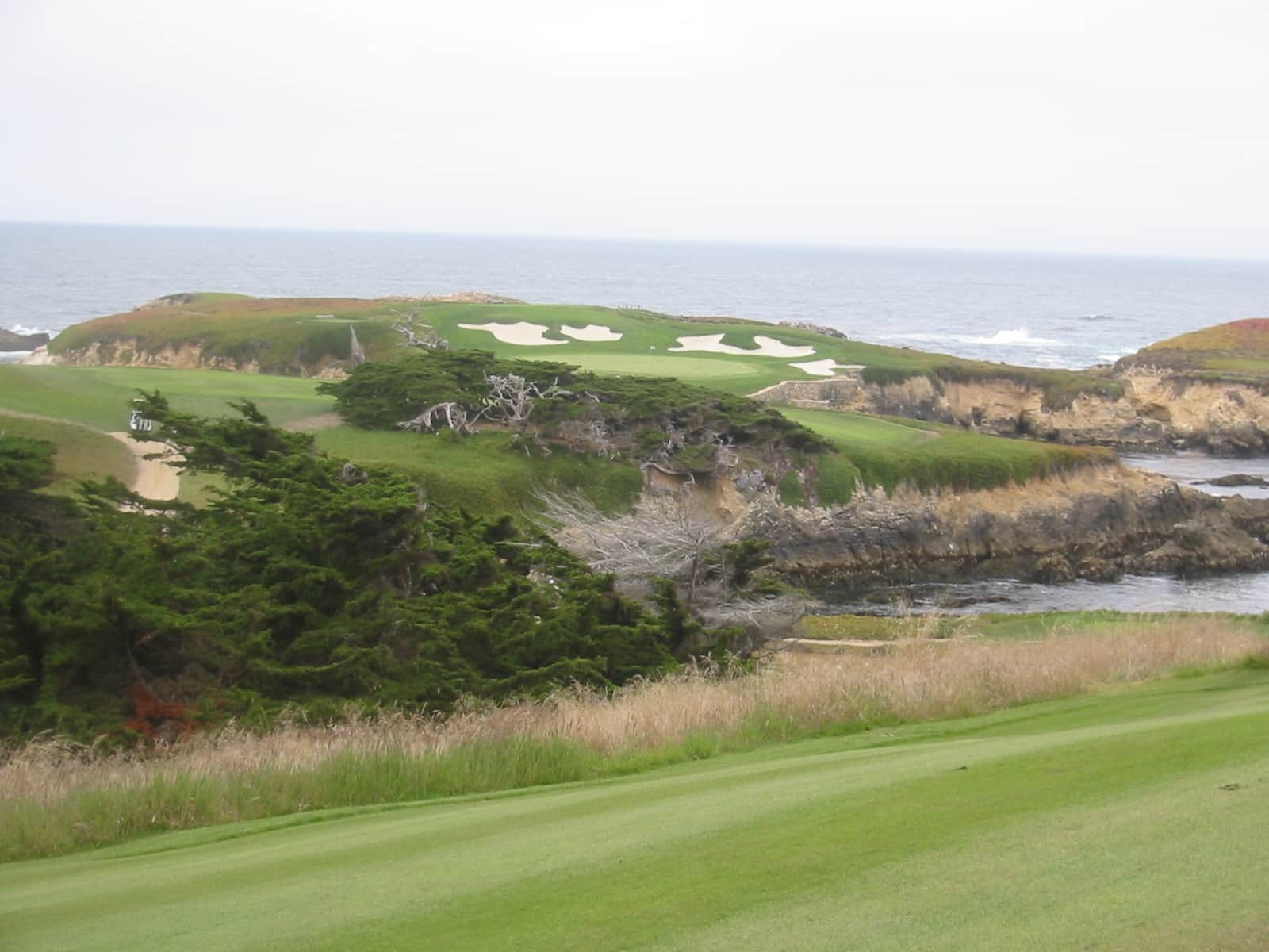 The famed par-3 16th hole and Pacific coastline seen from the clubhouse at Cypress Point Club, Pebble Beach, CA. Photo by schnaars (San Jose, CA), via Flickr / Wikimedia Commons, licensed CC BY-SA 2.0.