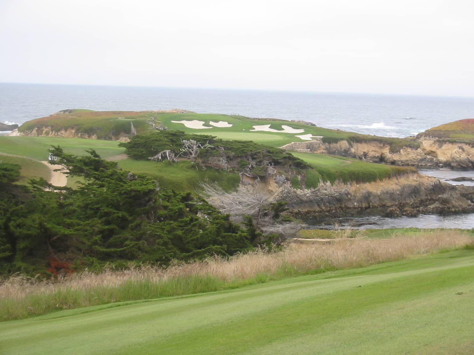 The famed par-3 16th hole and Pacific coastline seen from the clubhouse at Cypress Point Club, Pebble Beach, CA. Photo by schnaars (San Jose, CA), via Flickr / Wikimedia Commons, licensed CC BY-SA 2.0.