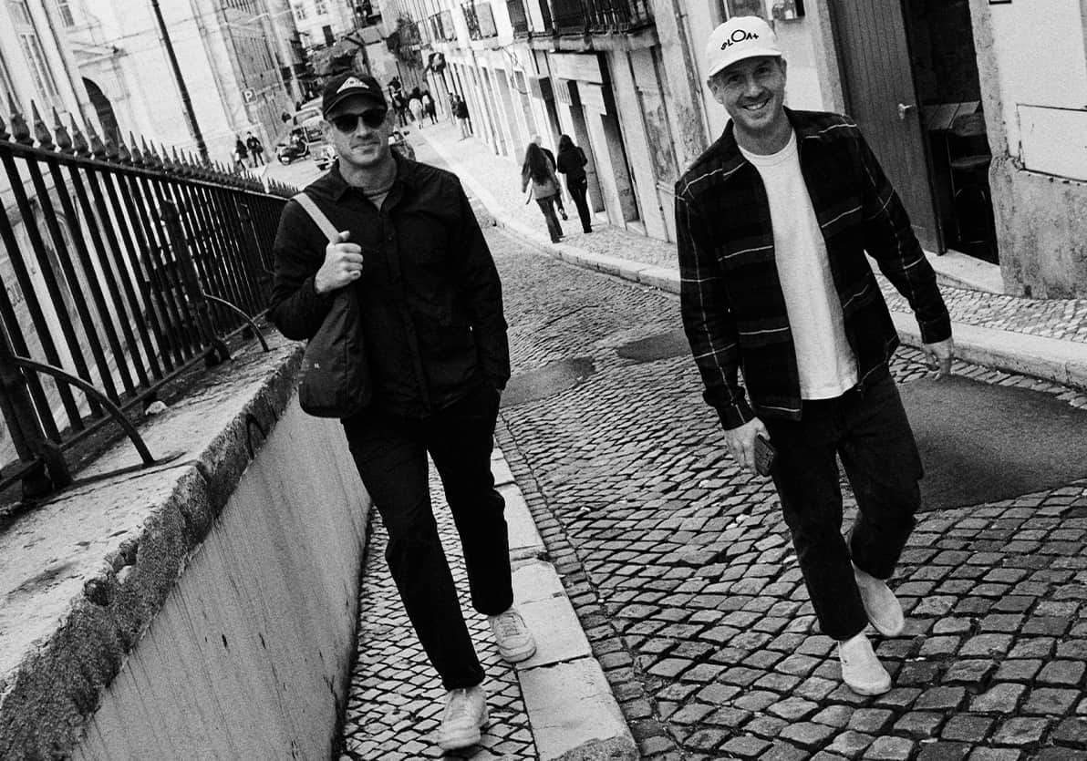 SLOAT founders Daniel Fibiger and Teague Moriarty walking together in SLOAT apparel. Photo courtesy of SLOAT, from the official journal article An Ode to the Outerlands: https://sloat.cc/blogs/journal/intro-letter-an-ode-to-the-outerlands